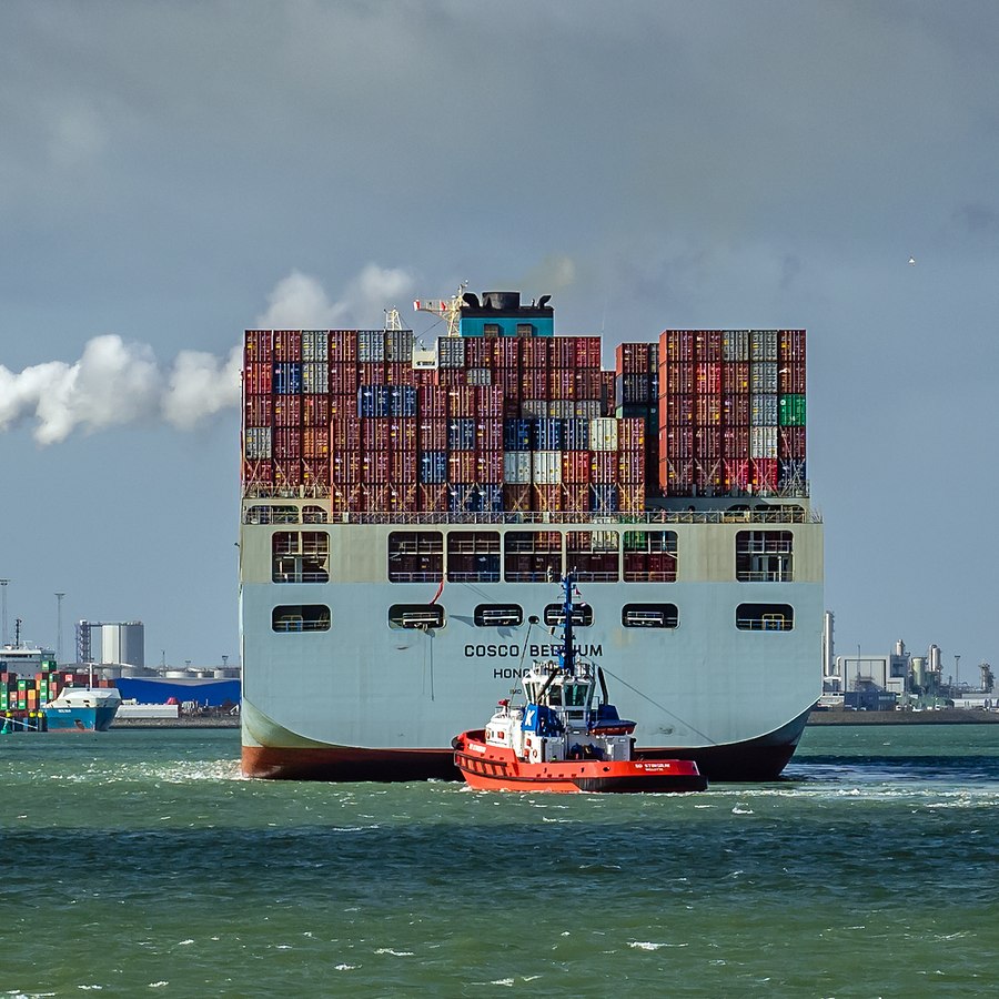 Container ship and tugboat at a global trade port